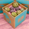 A box of fresh sugar apple fruits, displaying their green scaly rind and creamy flesh