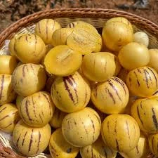 Image of Fresh Pepino Melons with vibrant yellow and purple-striped skin and juicy, pale green flesh